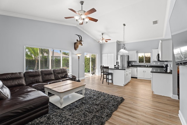 4620 SE Winter Haven Ct, Stuart, FL 34997 - living area featuring ceiling fan, light wood finished floors, high vaulted ceiling, ornamental molding, and baseboards