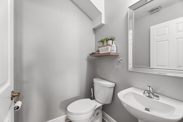 4620 SE Winter Haven Ct, Stuart, FL 34997 - bathroom featuring a sink, toilet, and baseboards