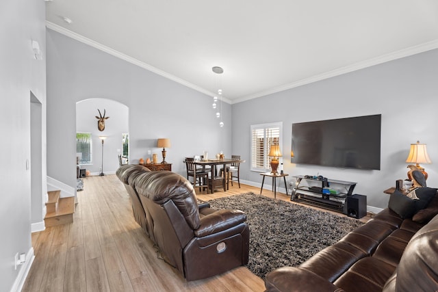 4620 SE Winter Haven Ct, Stuart, FL 34997 - living area with ornamental molding, light wood-type flooring, baseboards, stairway, and arched walkways