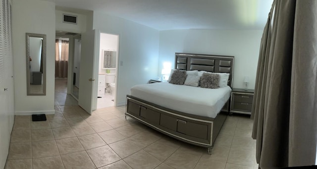 4441 NW 16th St Unit J210, Lauderhill, FL 33313 - bedroom featuring light tile patterned floors and ensuite bath