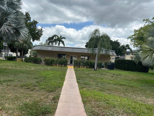 4441 NW 16th St Unit J210, Lauderhill, FL 33313 - view of front of house with a front lawn
