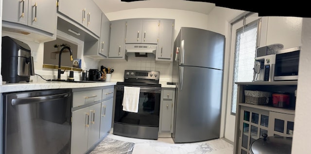 4441 NW 16th St Unit J210, Lauderhill, FL 33313 - kitchen featuring appliances with stainless steel finishes, gray cabinets, light marble finish flooring, and under cabinet range hood
