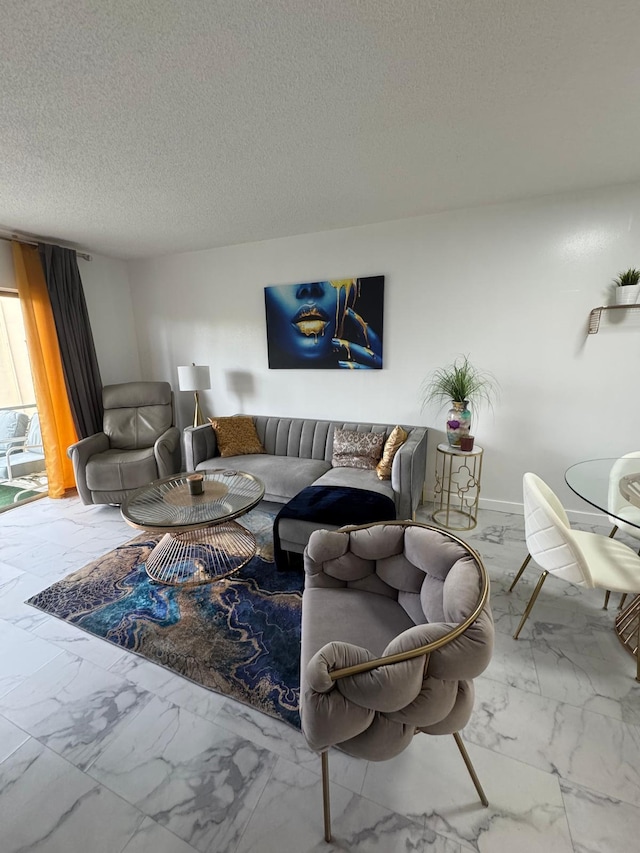 living room featuring marble look tiles, a textured ceiling, and baseboards