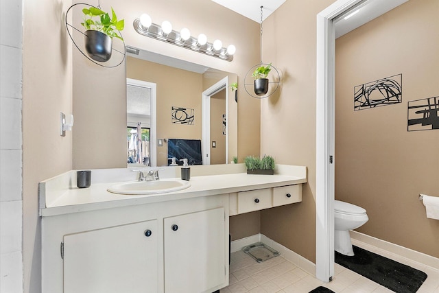 11 Meadows Dr, Boynton Beach, FL 33436 - bathroom featuring toilet, vanity, tile patterned floors, and baseboards