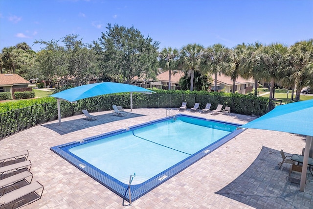 11 Meadows Dr, Boynton Beach, FL 33436 - community pool with fence and a patio area