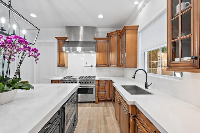 17736 103rd Ter N, Jupiter, FL 33478 - kitchen with wall chimney range hood, stainless steel appliances, a sink, brown cabinetry, and light countertops