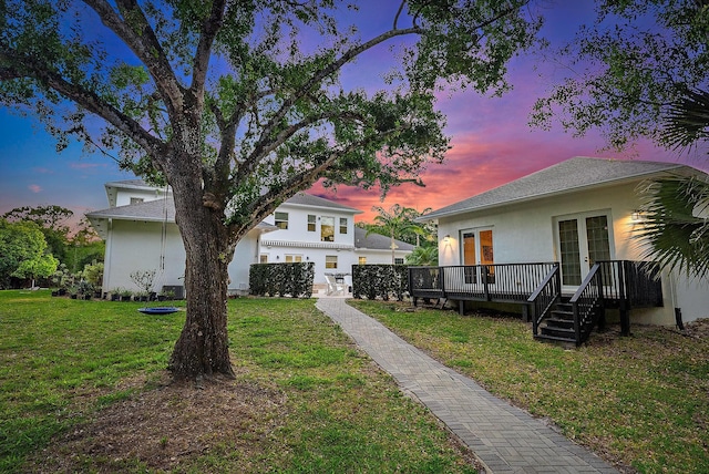 17736 103rd Ter N, Jupiter, FL 33478 - view of grassy yard with french doors and a wooden deck