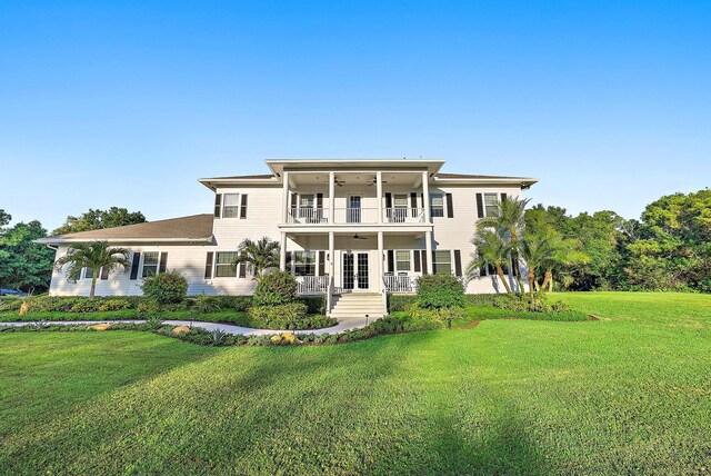 17736 103rd Ter N, Jupiter, FL 33478 - back of property featuring a balcony, a lawn, french doors, ceiling fan, and a porch