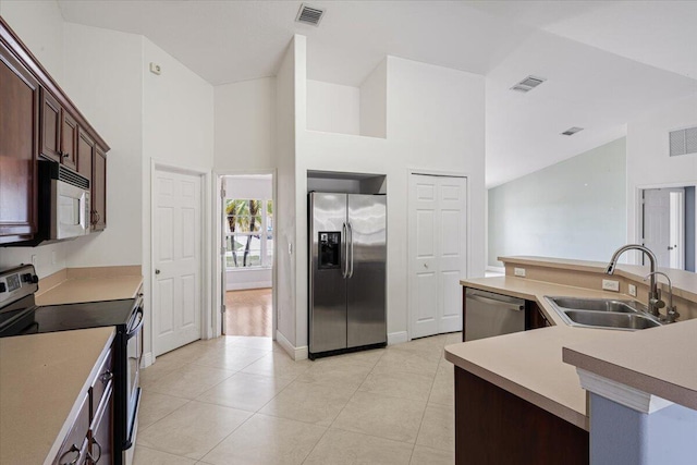 3925 SW Helmlinger St, Port Saint Lucie, FL 34953 - kitchen featuring appliances with stainless steel finishes, a sink, light countertops, high vaulted ceiling, and light tile patterned floors