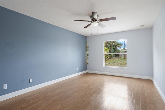 3925 SW Helmlinger St, Port Saint Lucie, FL 34953 - spare room with ceiling fan, wood finished floors, and baseboards