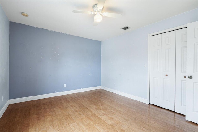 3925 SW Helmlinger St, Port Saint Lucie, FL 34953 - unfurnished bedroom featuring light wood finished floors, a closet, baseboards, and ceiling fan