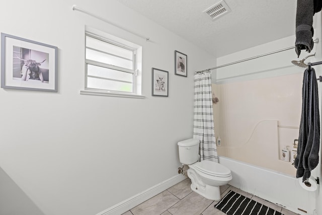 6905 Bayard Rd, Fort Pierce, FL 34951 - bathroom featuring toilet, shower / tub combo with curtain, tile patterned floors, baseboards, and a textured ceiling