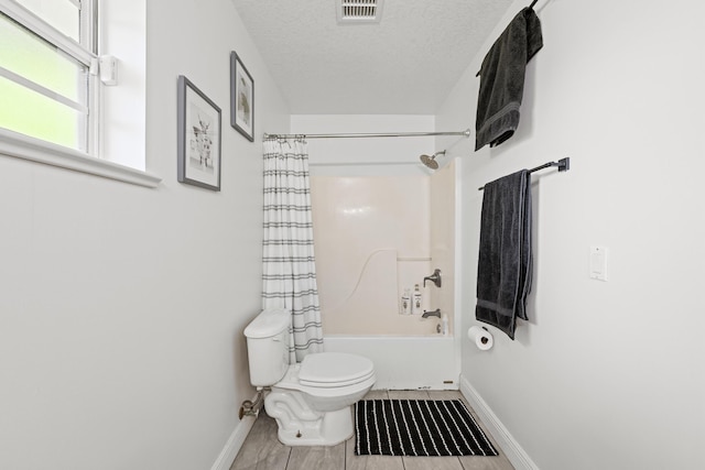 6905 Bayard Rd, Fort Pierce, FL 34951 - bathroom featuring baseboards, toilet, shower / bathtub combination with curtain, and a textured ceiling