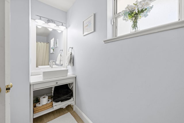 6905 Bayard Rd, Fort Pierce, FL 34951 - bathroom with vanity, wood finished floors, and baseboards
