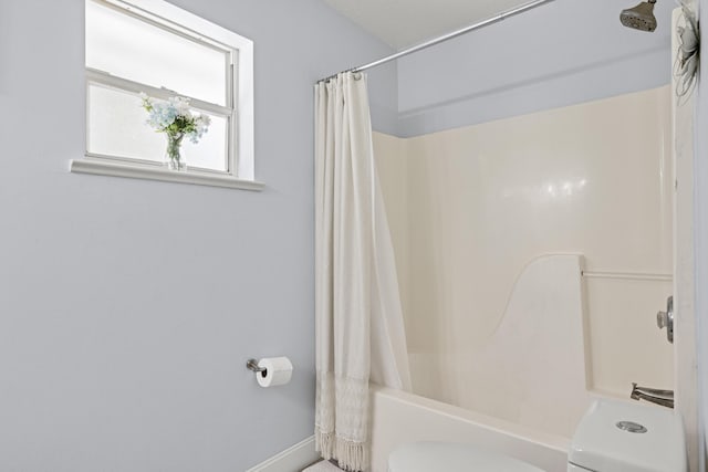 6905 Bayard Rd, Fort Pierce, FL 34951 - bathroom featuring toilet, shower / bathtub combination with curtain, and baseboards