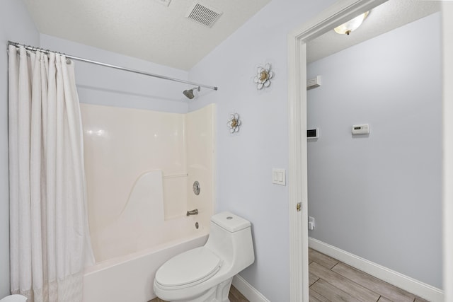 6905 Bayard Rd, Fort Pierce, FL 34951 - full bath featuring toilet, shower / tub combo, wood finish floors, and baseboards