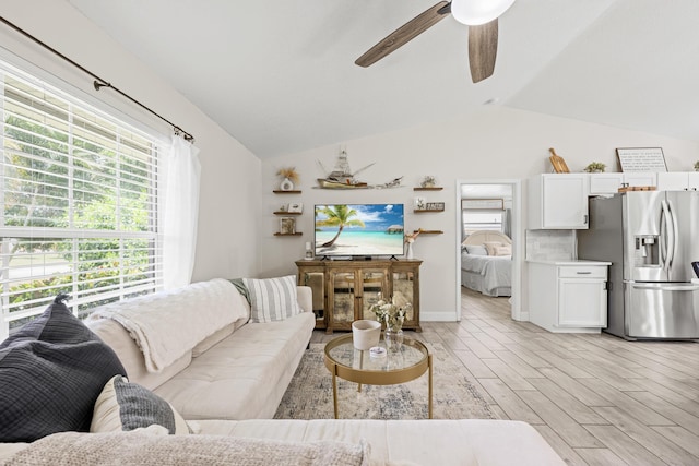 6905 Bayard Rd, Fort Pierce, FL 34951 - living area featuring vaulted ceiling, healthy amount of natural light, ceiling fan, and light wood-style floors