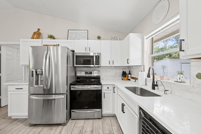 6905 Bayard Rd, Fort Pierce, FL 34951 - kitchen featuring appliances with stainless steel finishes, lofted ceiling, a sink, light countertops, and tasteful backsplash
