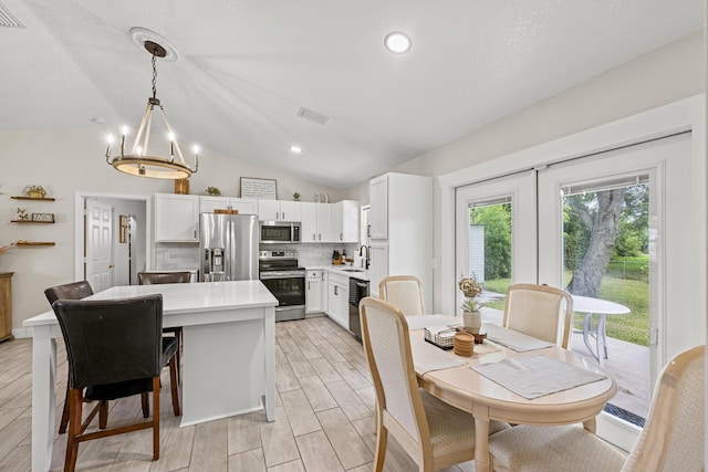 6905 Bayard Rd, Fort Pierce, FL 34951 - dining space featuring a chandelier, lofted ceiling, light wood-style flooring, and recessed lighting