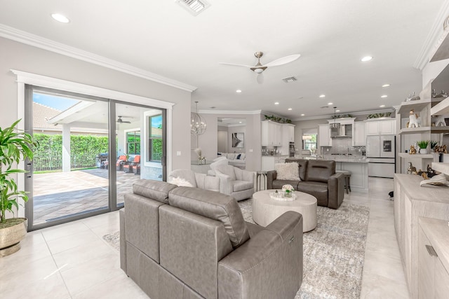 5211 SW Blue Daze Way, Palm City, FL 34990 - living area with a ceiling fan, crown molding, healthy amount of natural light, recessed lighting, and light tile patterned floors