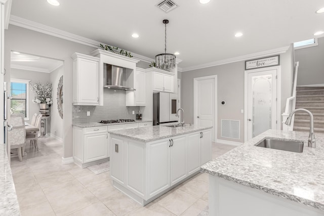 5211 SW Blue Daze Way, Palm City, FL 34990 - kitchen with a sink, refrigerator, wall chimney exhaust hood, a center island with sink, and tasteful backsplash