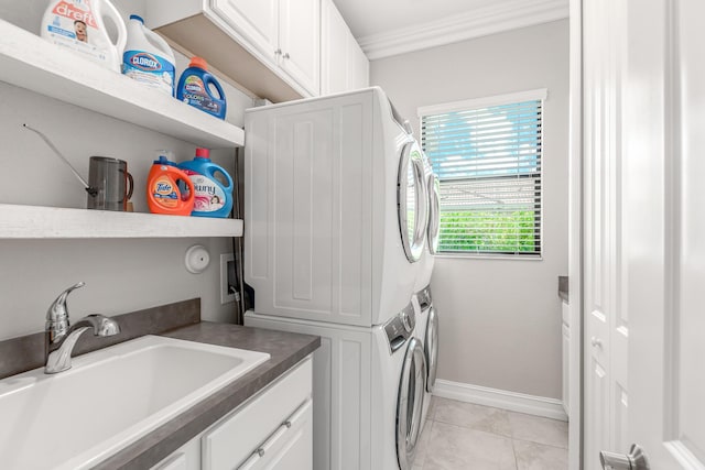 5211 SW Blue Daze Way, Palm City, FL 34990 - washroom with stacked washing machine and dryer, cabinet space, ornamental molding, light tile patterned flooring, and baseboards