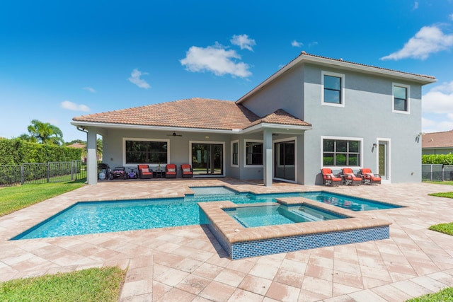 5211 SW Blue Daze Way, Palm City, FL 34990 - view of pool featuring a patio, fence, an outdoor hangout area, and a pool with connected hot tub