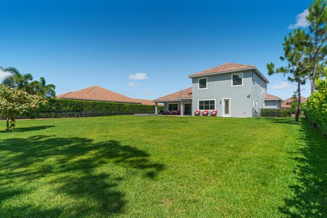 5211 SW Blue Daze Way, Palm City, FL 34990 - back of house featuring stucco siding and a patio