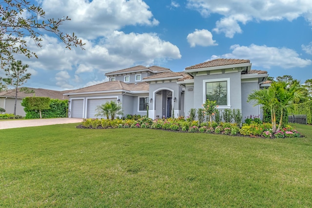 5211 SW Blue Daze Way, Palm City, FL 34990 - mediterranean / spanish-style house featuring an attached garage, driveway, stucco siding, a front yard, and a tiled roof