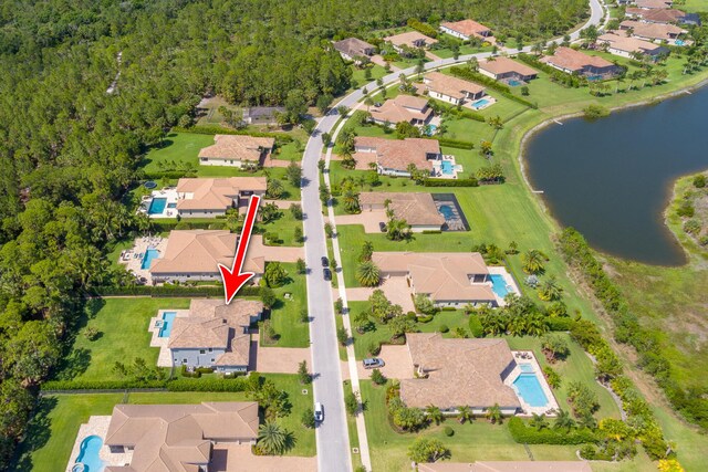 5211 SW Blue Daze Way, Palm City, FL 34990 - aerial view of property and surrounding area with nearby suburban area, a large body of water, and a heavily wooded area