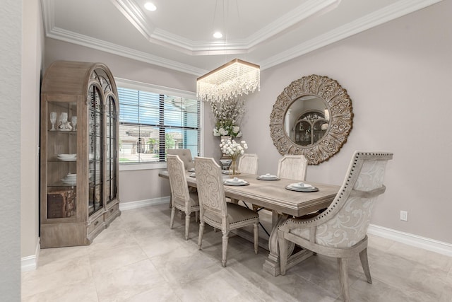 5211 SW Blue Daze Way, Palm City, FL 34990 - dining area featuring a tray ceiling, ornamental molding, a chandelier, and baseboards