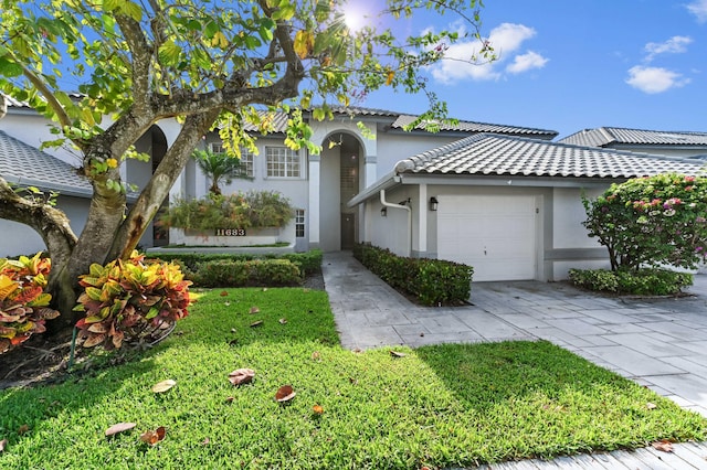 11683 Briarwood Cir Unit 4, Boynton Beach, FL 33437 - view of front of house with stucco siding, a garage, concrete driveway, and a front yard