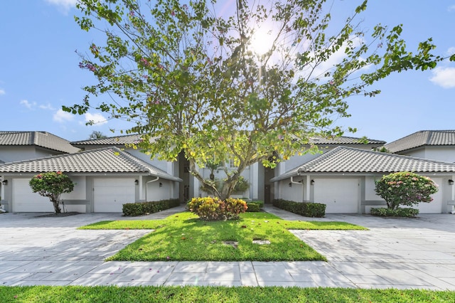 11683 Briarwood Cir Unit 4, Boynton Beach, FL 33437 - view of front of home with stucco siding, a garage, and a tiled roof