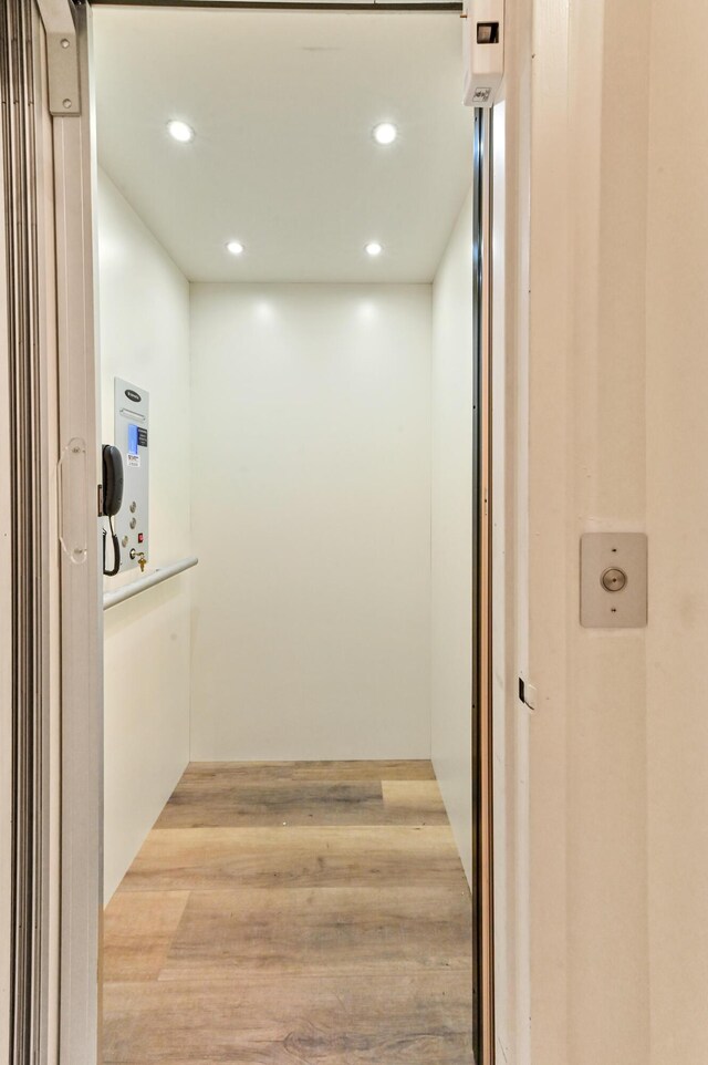 11683 Briarwood Cir Unit 4, Boynton Beach, FL 33437 - corridor featuring elevator, light wood-type flooring, and recessed lighting