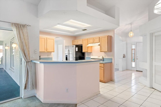531 SE Evergreen Ter, Port Saint Lucie, FL 34983 - kitchen featuring stainless steel refrigerator with ice dispenser, light brown cabinets, a peninsula, range, and under cabinet range hood