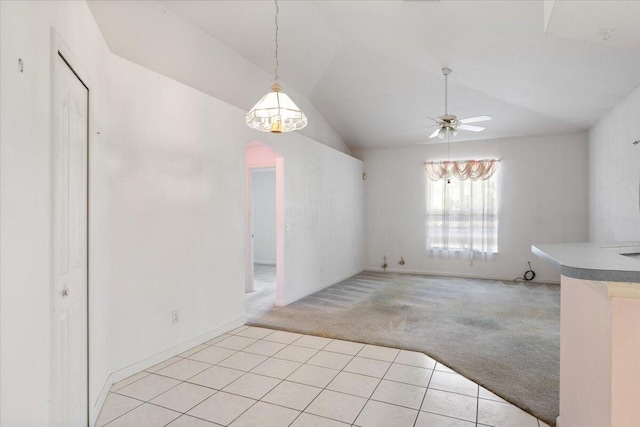 531 SE Evergreen Ter, Port Saint Lucie, FL 34983 - unfurnished dining area featuring light carpet, a ceiling fan, lofted ceiling, arched walkways, and light tile patterned flooring