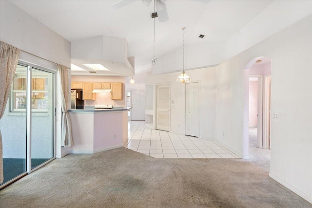 531 SE Evergreen Ter, Port Saint Lucie, FL 34983 - kitchen with light carpet, light brown cabinets, arched walkways, freestanding refrigerator, and a ceiling fan