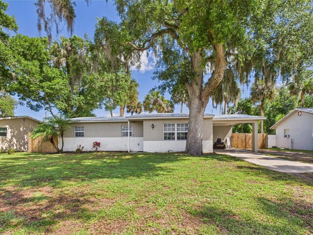 3307 SW 22nd St, Okeechobee, FL 34974 - ranch-style home with concrete driveway, an attached carport, stucco siding, and brick siding