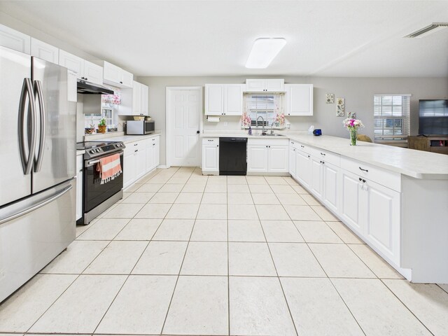 3307 SW 22nd St, Okeechobee, FL 34974 - kitchen with appliances with stainless steel finishes, a sink, a peninsula, under cabinet range hood, and light countertops