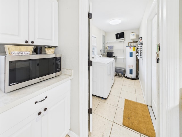 3307 SW 22nd St, Okeechobee, FL 34974 - laundry area featuring water heater, light tile patterned floors, and washer and clothes dryer