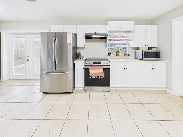 3307 SW 22nd St, Okeechobee, FL 34974 - kitchen with appliances with stainless steel finishes, light countertops, white cabinetry, and under cabinet range hood