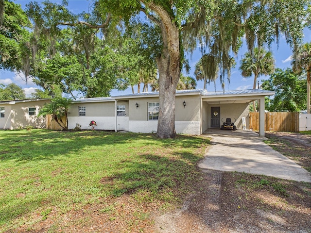 3307 SW 22nd St, Okeechobee, FL 34974 - ranch-style house featuring concrete driveway, an attached carport, brick siding, and stucco siding