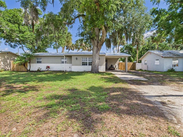 3307 SW 22nd St, Okeechobee, FL 34974 - back of property featuring dirt driveway, an attached carport, brick siding, and stucco siding