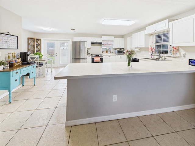 3307 SW 22nd St, Okeechobee, FL 34974 - kitchen featuring appliances with stainless steel finishes, a sink, under cabinet range hood, a desk, and a peninsula