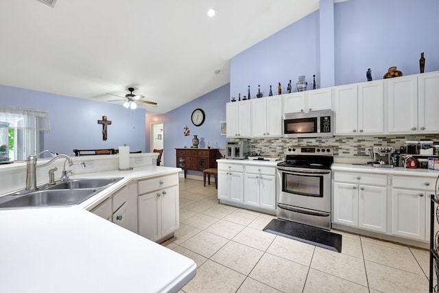 1226 SW San Antonio Ave, Port Saint Lucie, FL 34953 - kitchen with appliances with stainless steel finishes, a sink, lofted ceiling, decorative backsplash, and ceiling fan