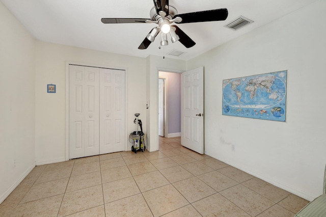 1226 SW San Antonio Ave, Port Saint Lucie, FL 34953 - unfurnished bedroom featuring light tile patterned flooring, baseboards, a closet, and ceiling fan