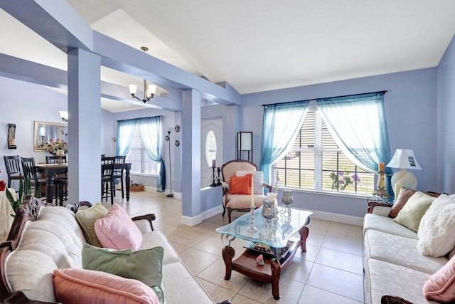 1226 SW San Antonio Ave, Port Saint Lucie, FL 34953 - living area with a chandelier, vaulted ceiling, light tile patterned flooring, and baseboards