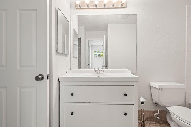 bathroom with toilet and vanity