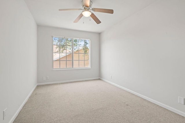 unfurnished room with carpet flooring, baseboards, and a ceiling fan