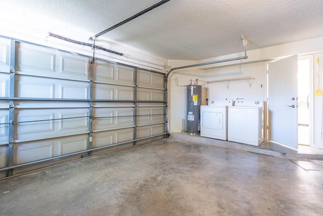 garage featuring electric water heater and washer and dryer